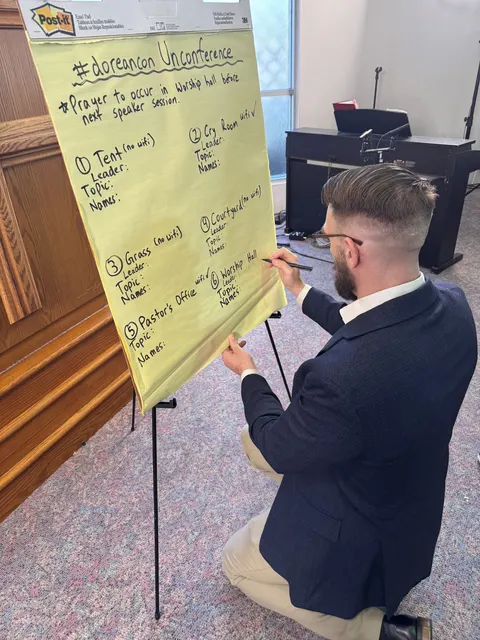 A speaker walking through the argument beside a flip chart