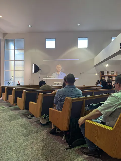 Attendees seated in the pews, listening to a message