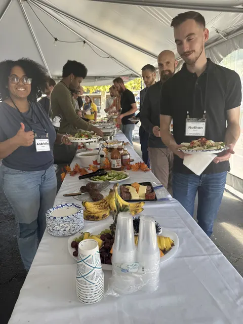 Attendees sharing a meal under the tent