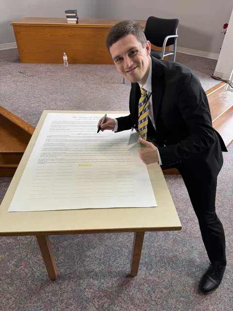 An attendee at the statement signing table