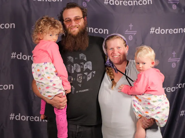 A father and children at the #doreancon photo backdrop