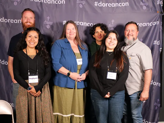 Attendees at the #doreancon photo backdrop